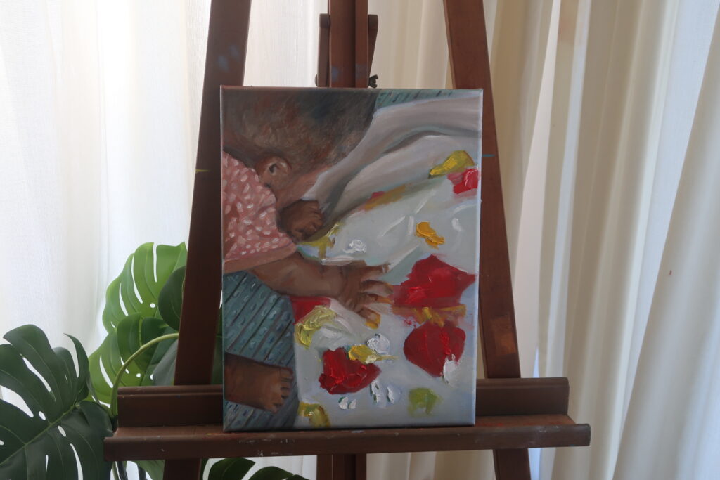 Painting of a baby playing with paint